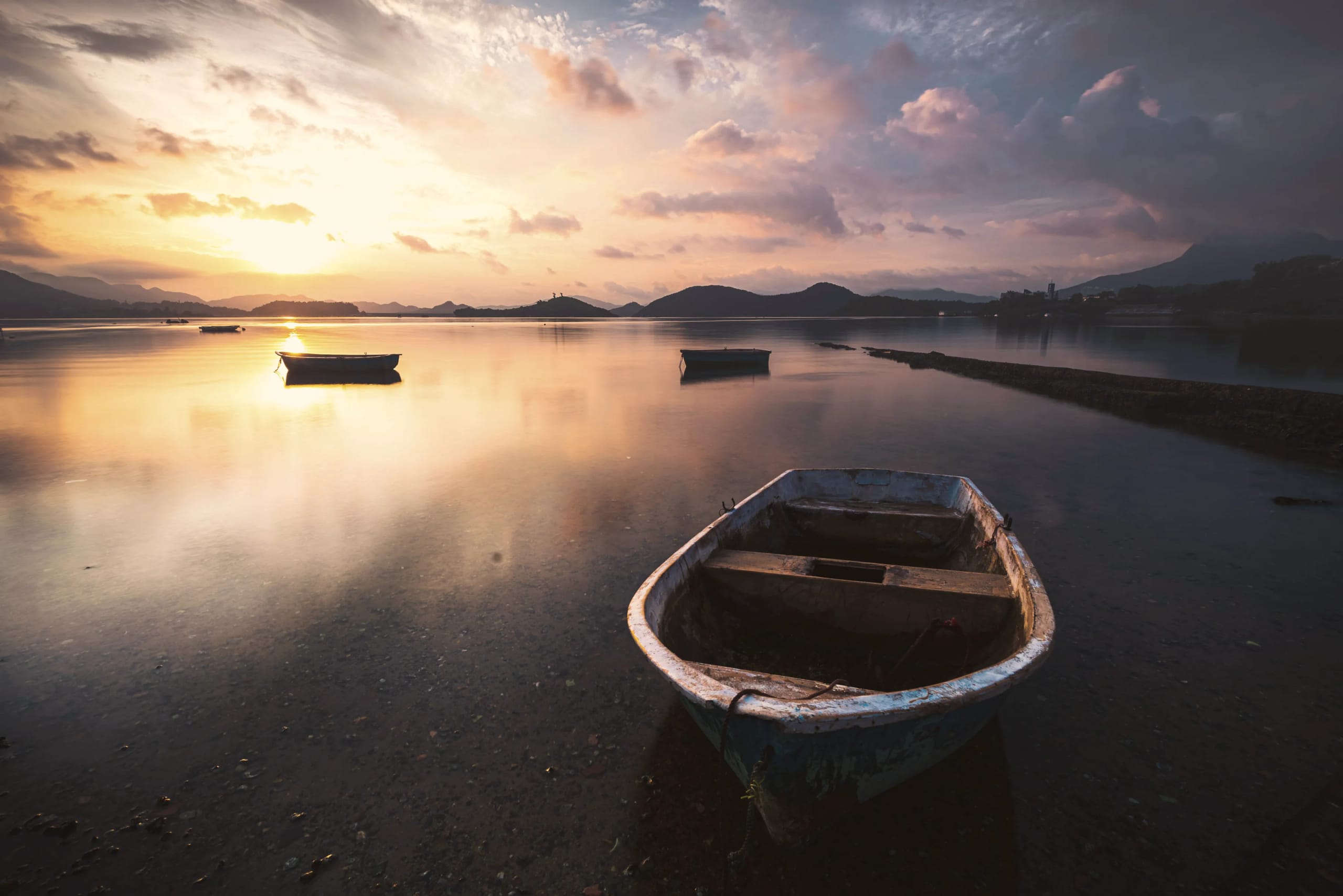 Calm lagoon at sunset with boats moored, Mauritius